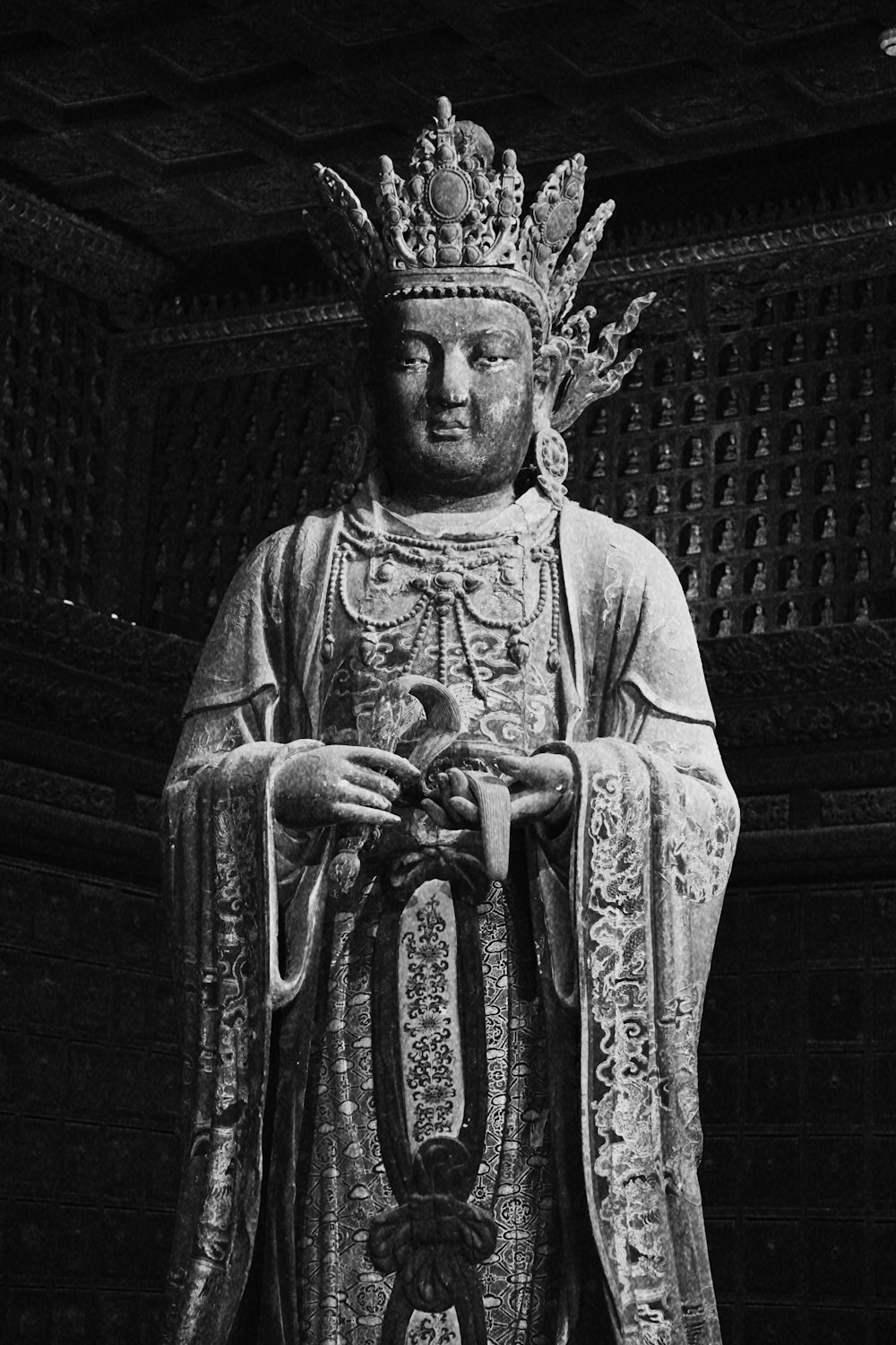 grayscale photo of man in robe statue