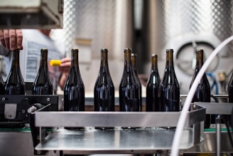 black glass bottles on stainless steel table