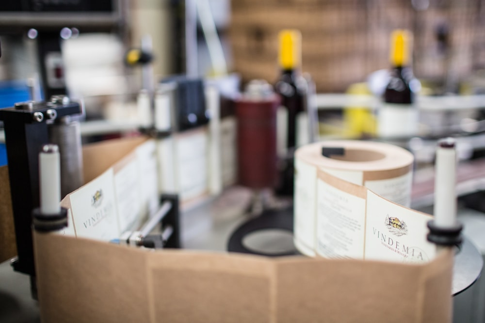 red and white plastic bottle on brown cardboard box