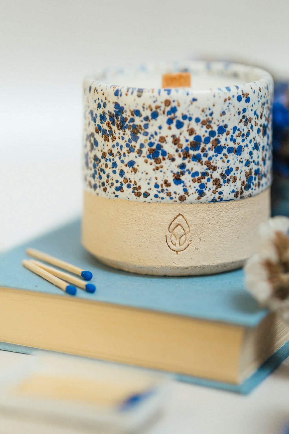 white and blue floral candle holder