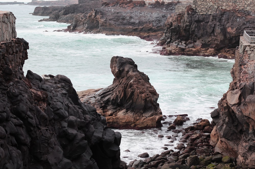 brown rock formation on sea during daytime