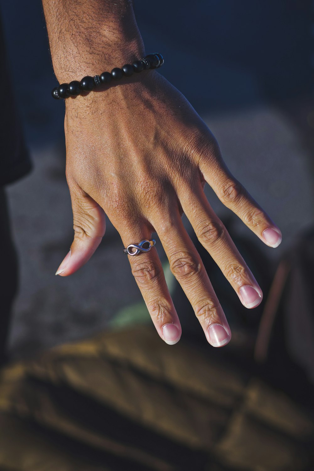 person wearing black beaded bracelet