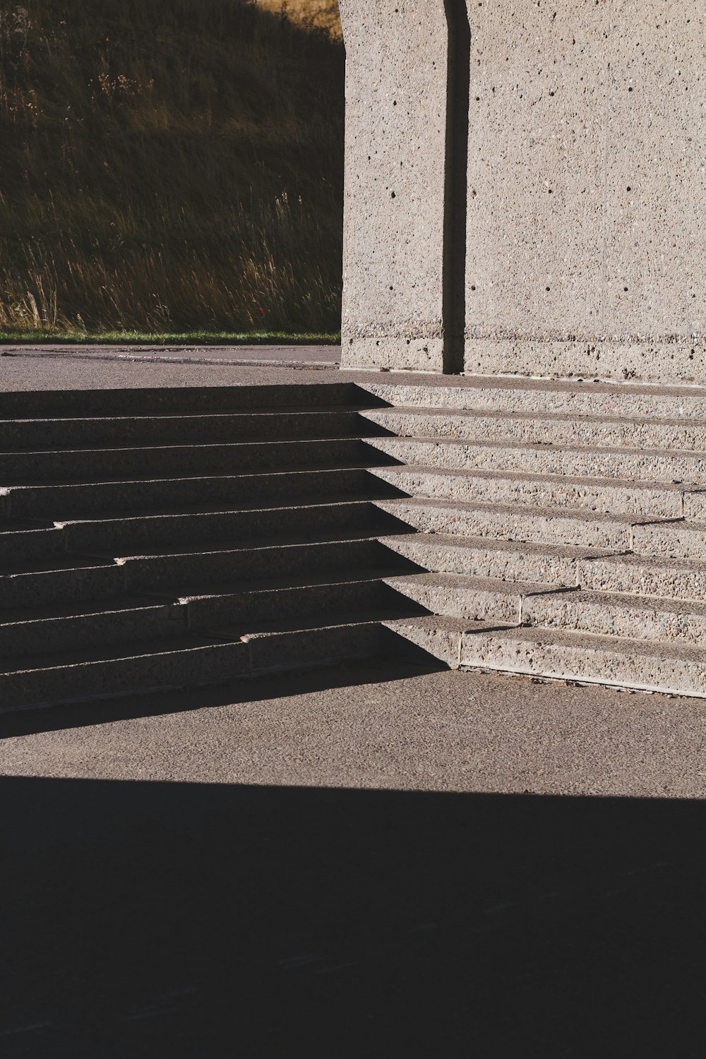 gray concrete stairs near green grass during daytime