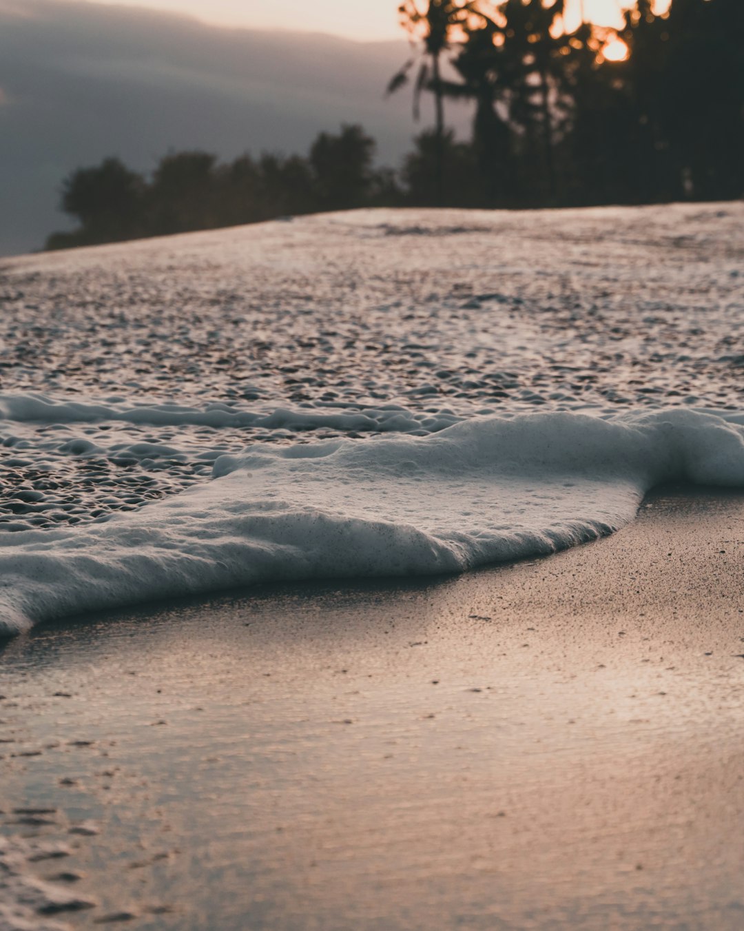 water waves on brown sand during daytime