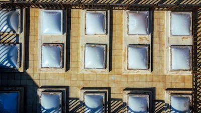 Close-up of hands fitting a skylight on a residential roof.