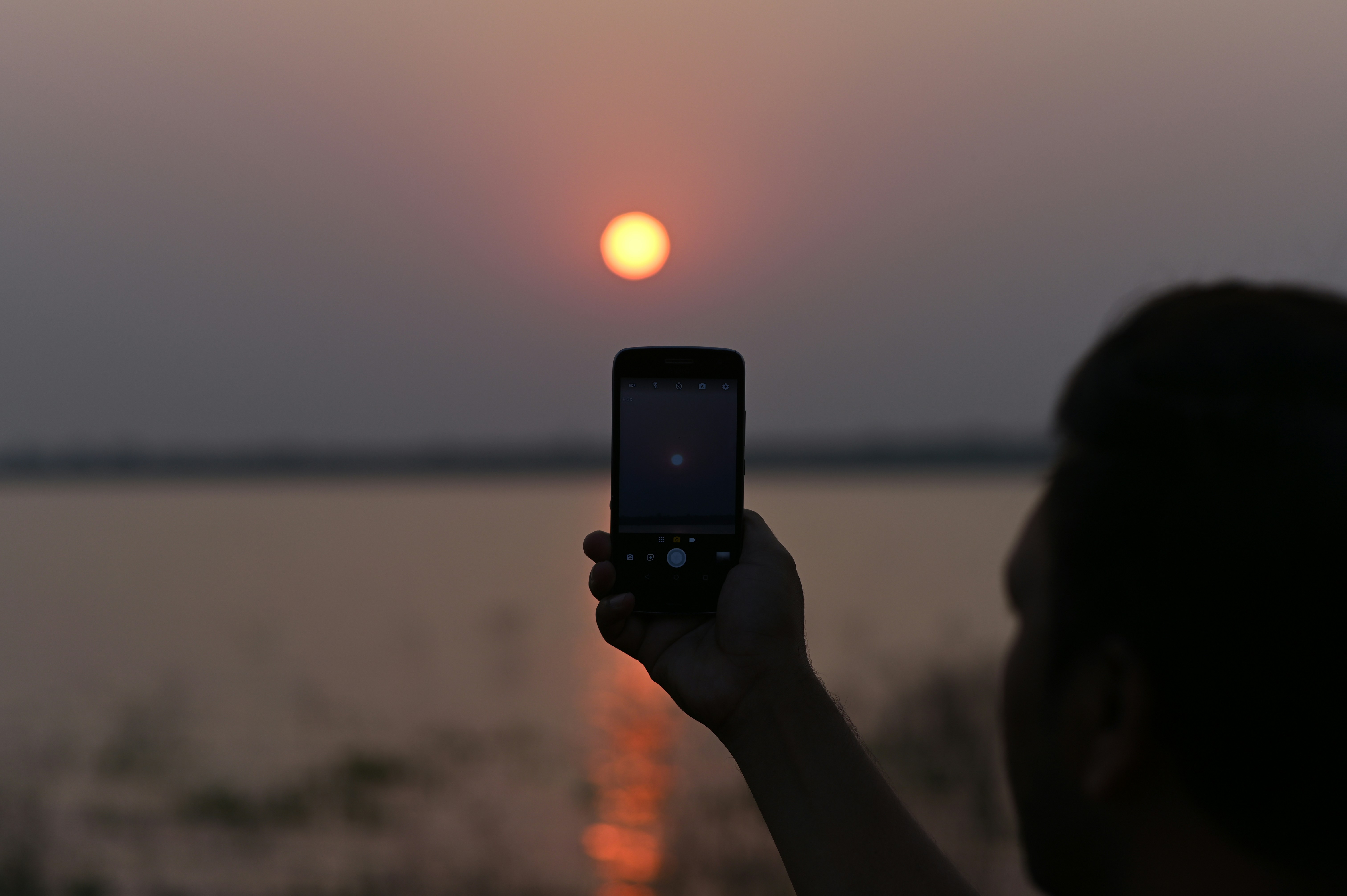 person holding black iphone 4