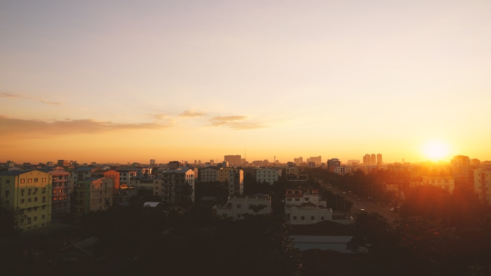 city buildings during sunset under cloudy sky