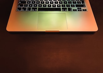 macbook pro on brown wooden table
