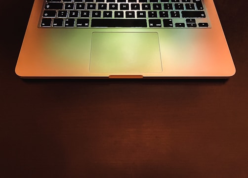 macbook pro on brown wooden table
