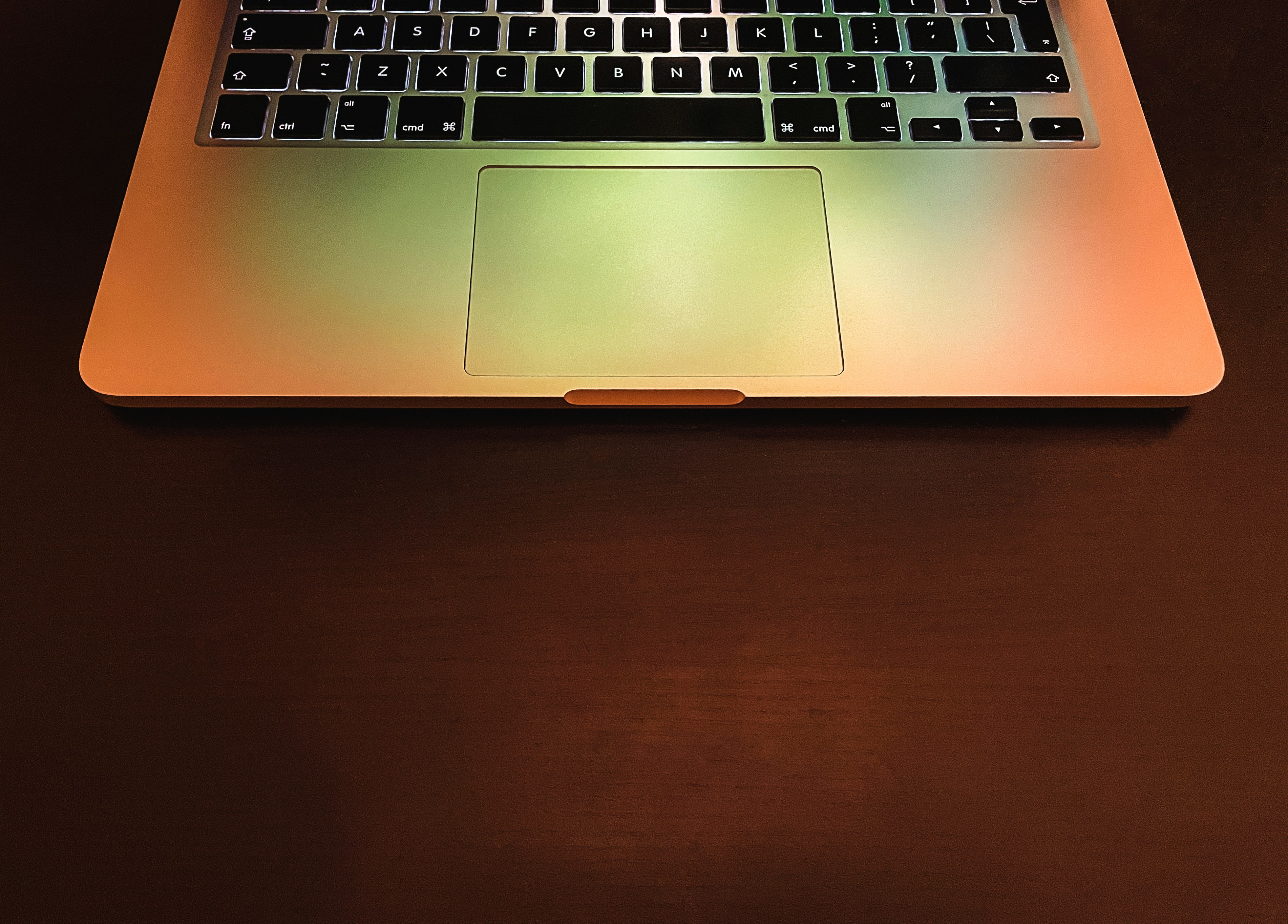 macbook pro on brown wooden table