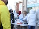 people standing near white table during daytime