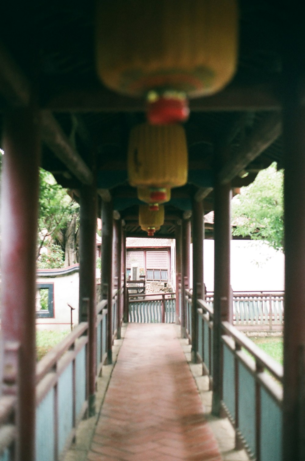 red and yellow lantern hanging on brown wooden post