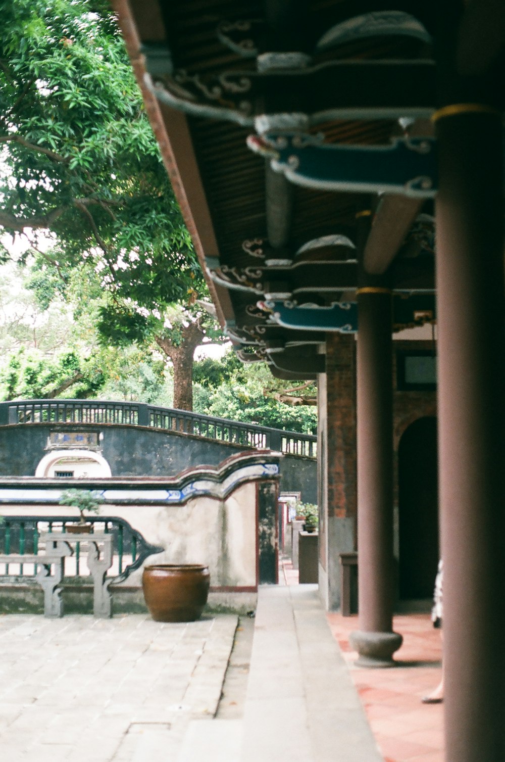 brown wooden arch near green trees during daytime