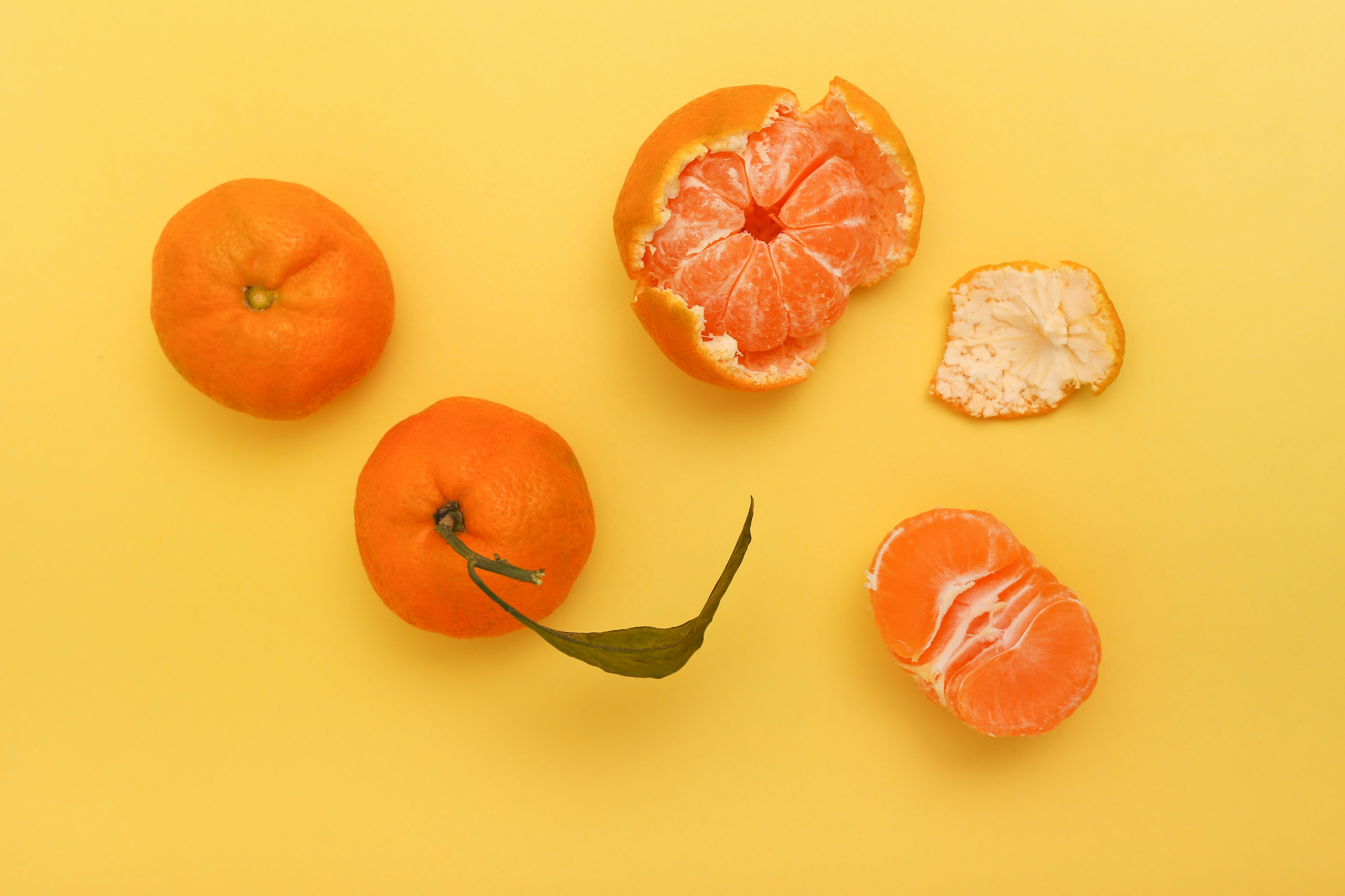 Tangerines on yellow background