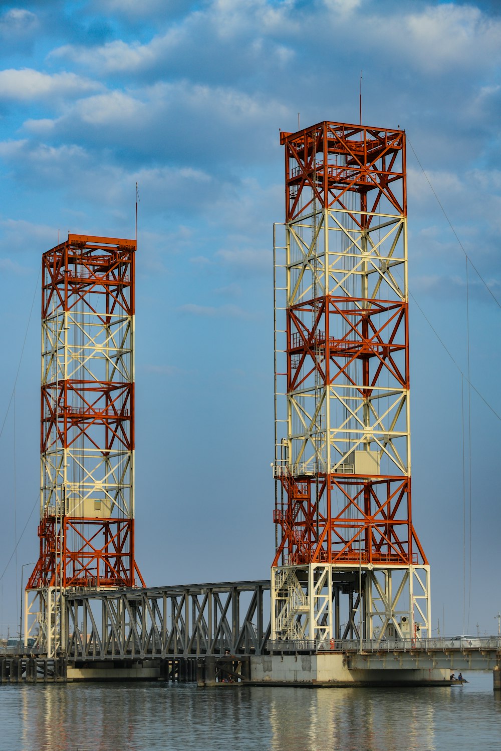 red and white metal tower under blue sky during daytime