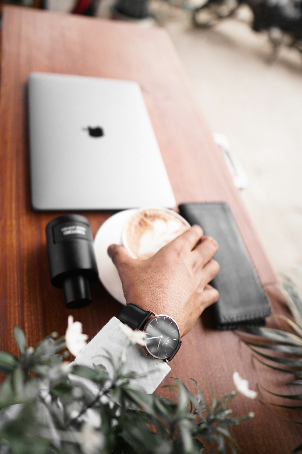 person in black watch holding black dslr camera