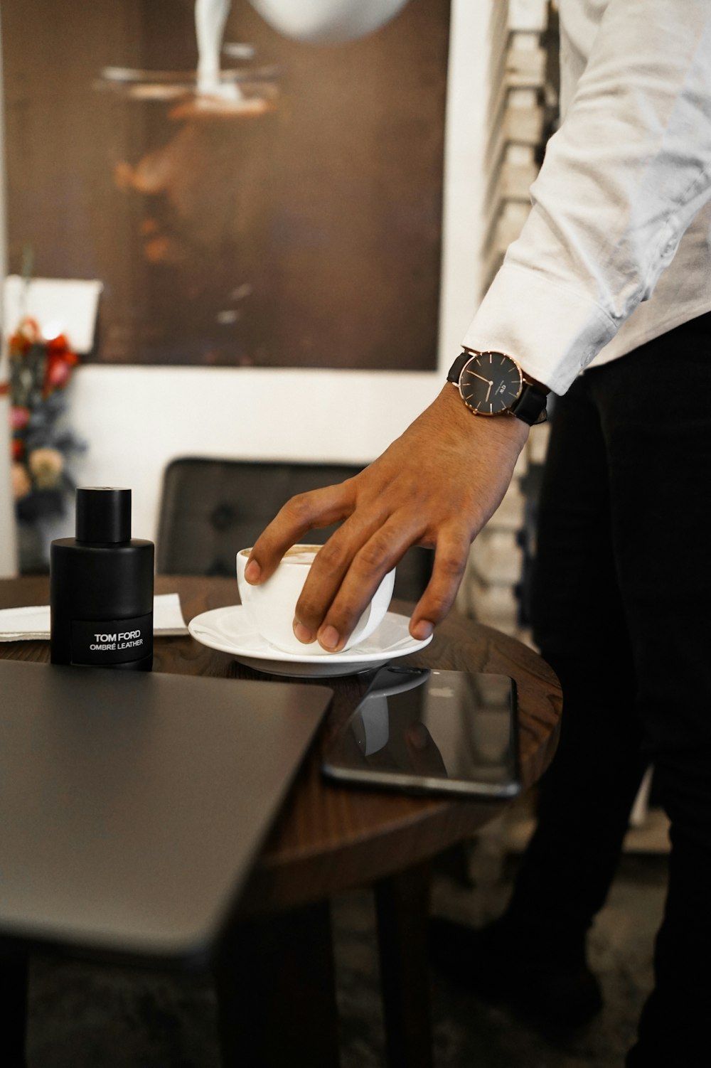 a man is holding a white mouse on a white plate