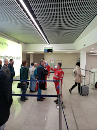 a group of people standing around in an airport