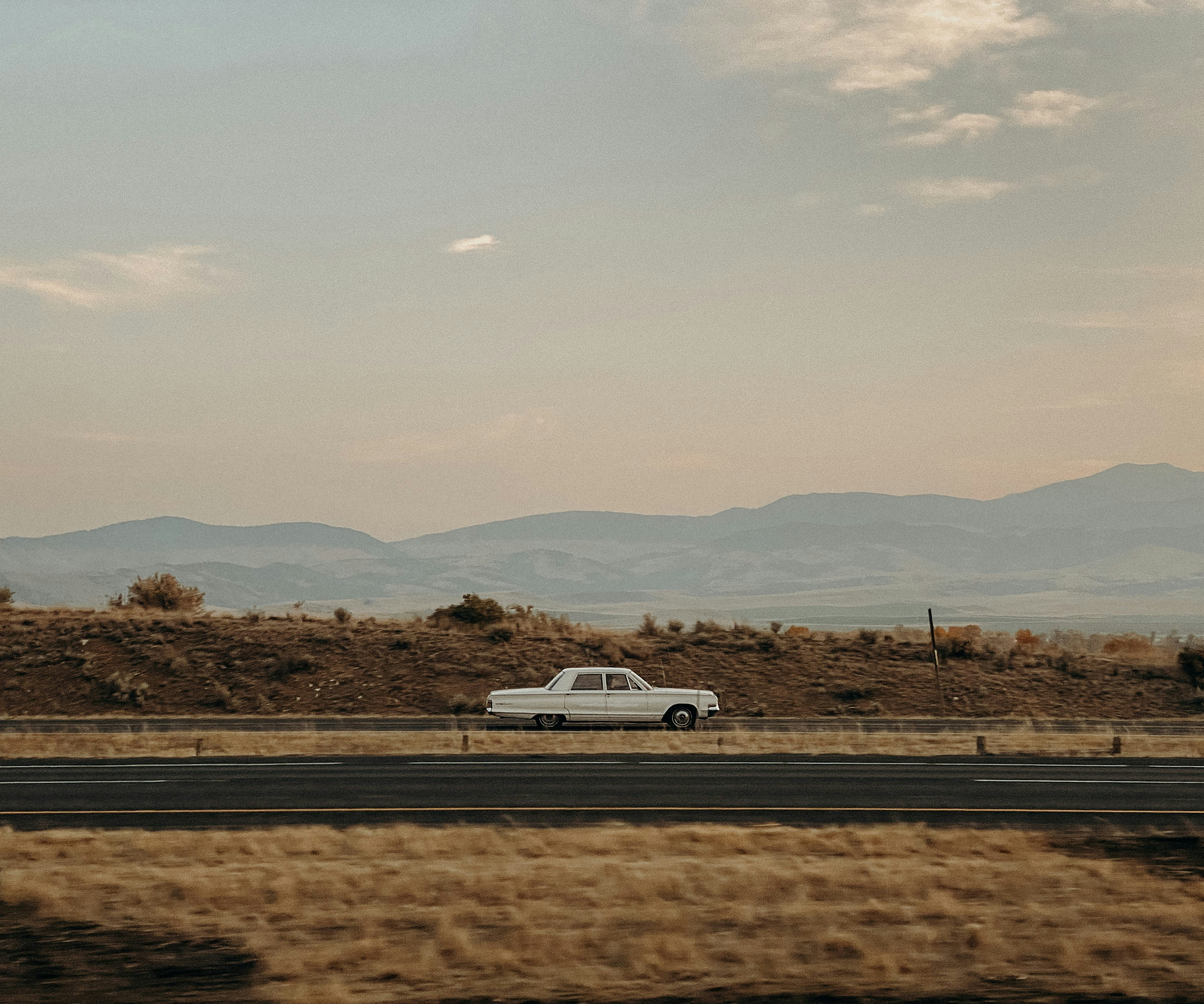 white-car-on-road-during-daytime