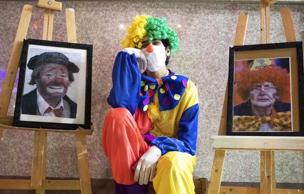 2 boys wearing blue and yellow costume sitting on brown wooden chair