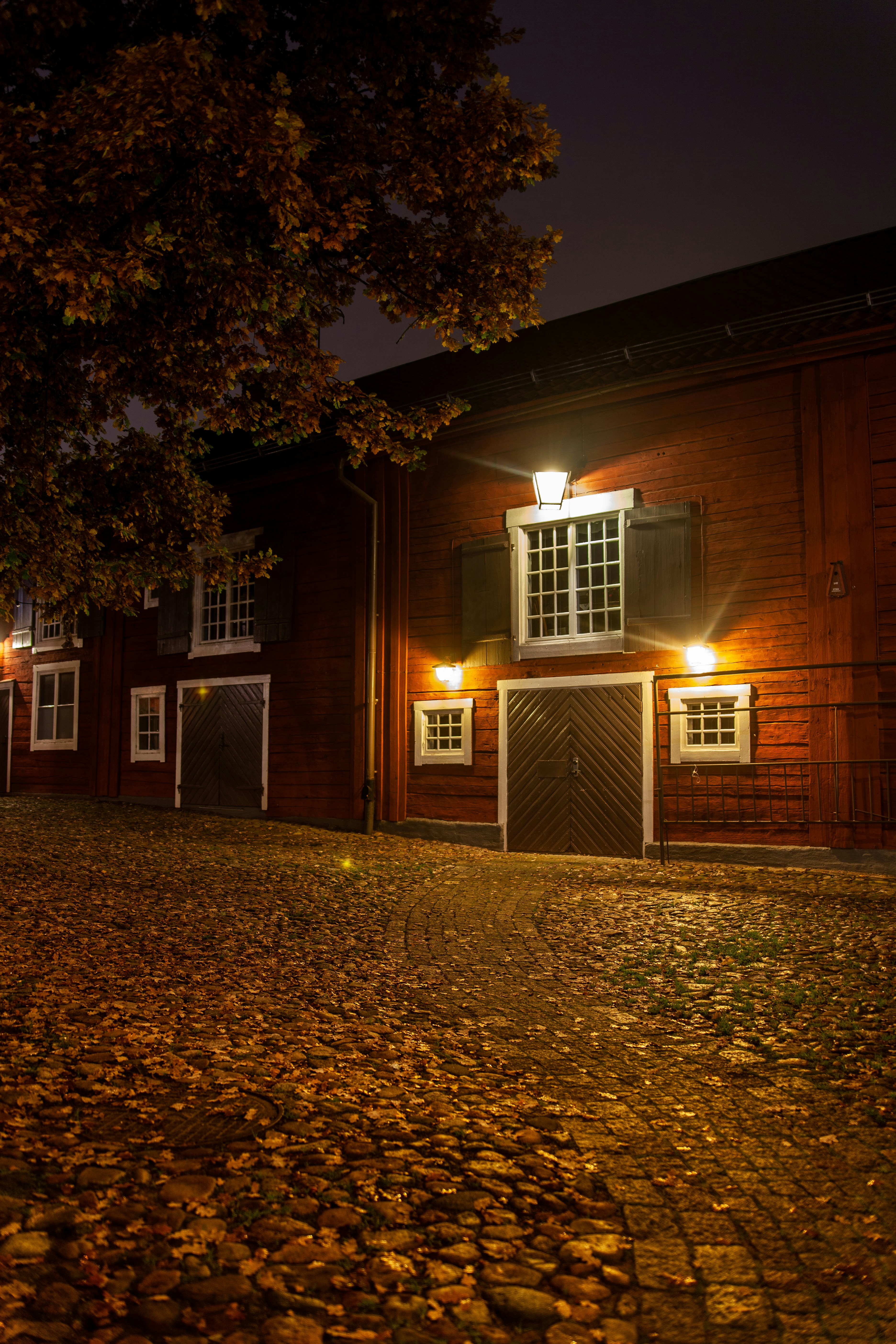 brown wooden building with lights turned on during night time