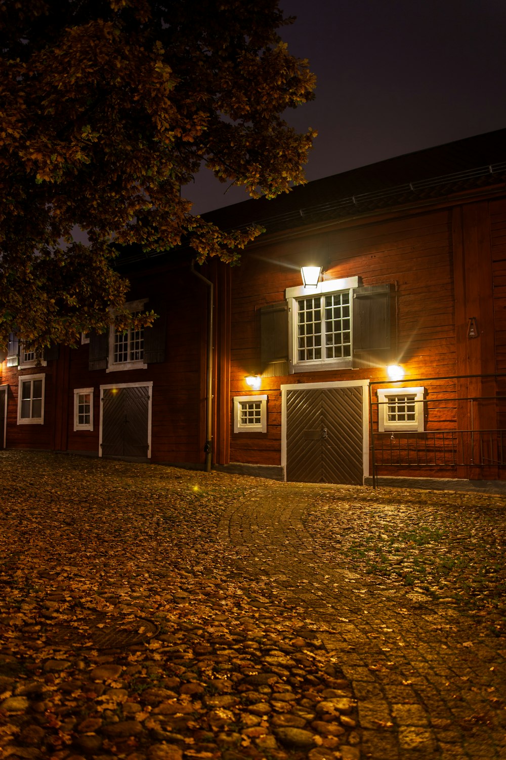 brown wooden building with lights turned on during night time