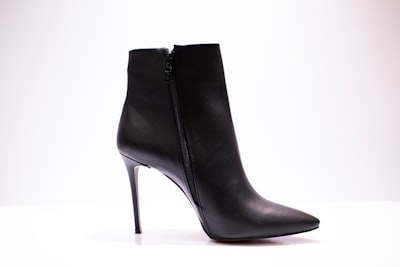 black leather boot on white surface boots google meet background
