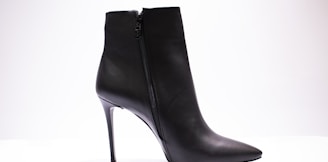 black leather boot on white surface