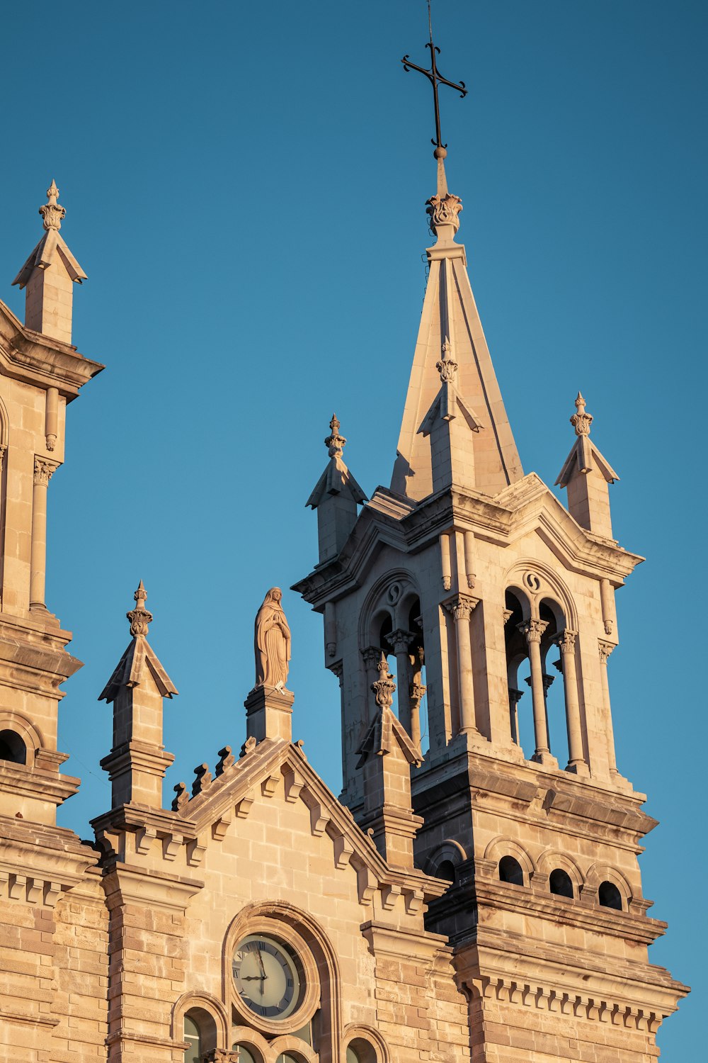 brown and white concrete church under blue sky during daytime