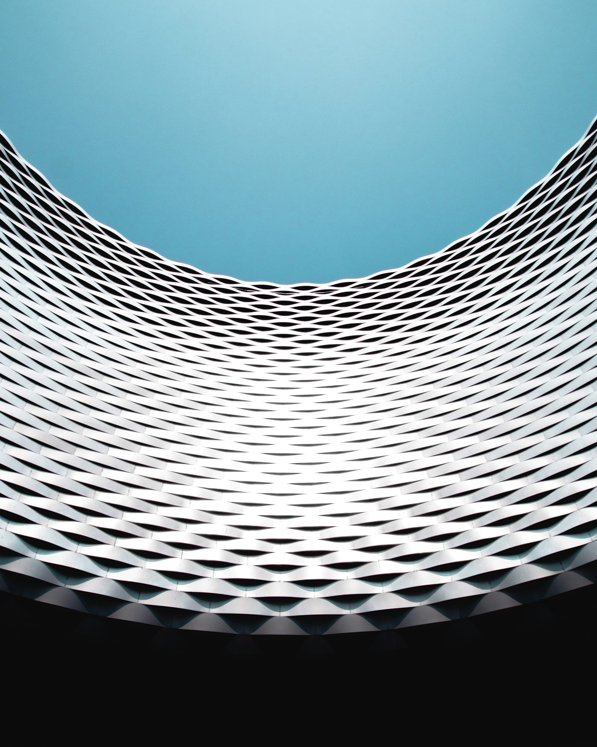 an abstract photo of a building with a blue sky in the background
