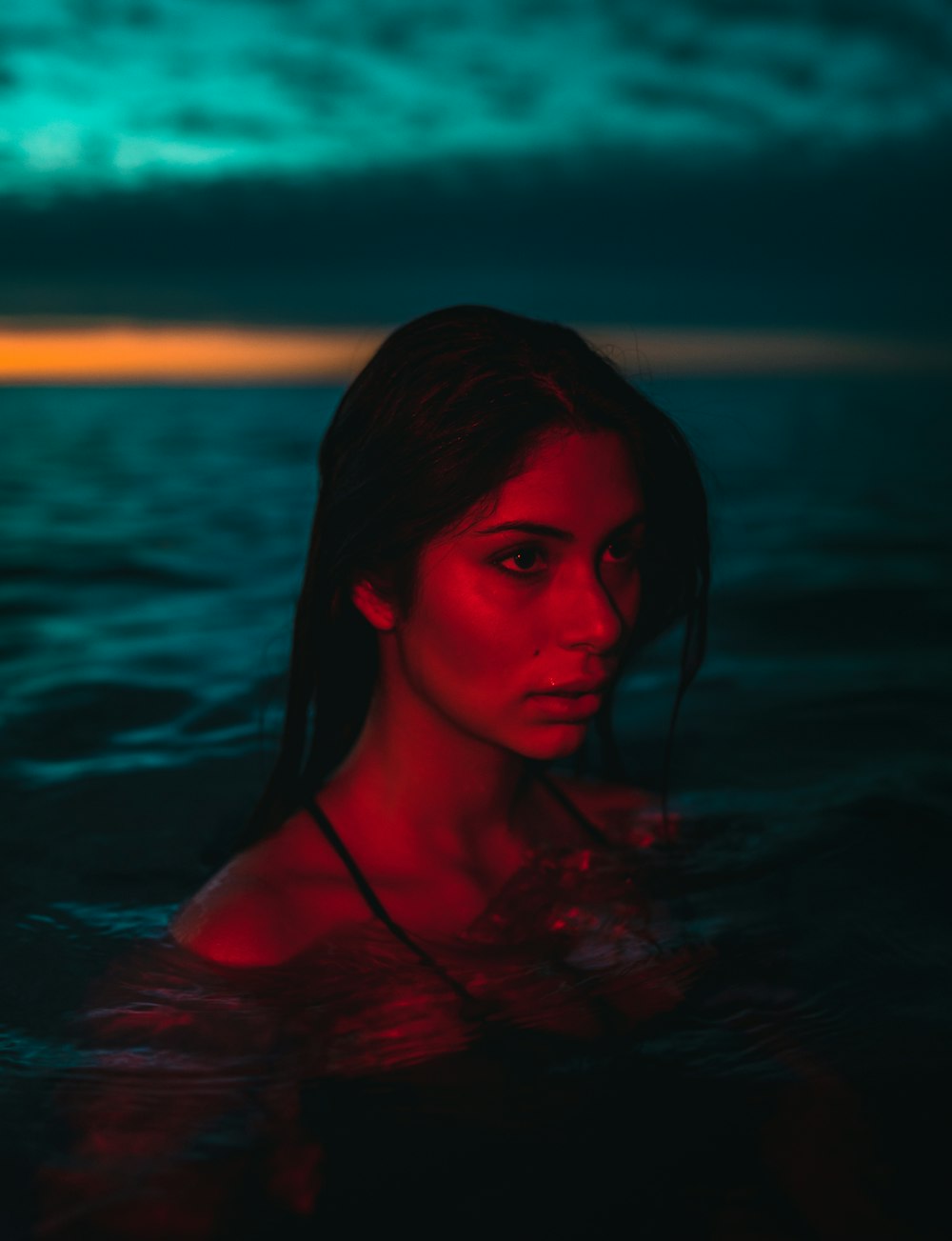 woman in water during sunset