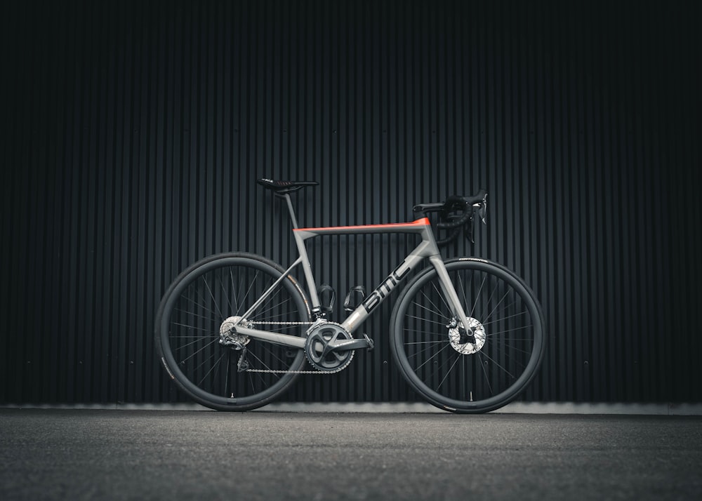 a bike parked in front of a black wall