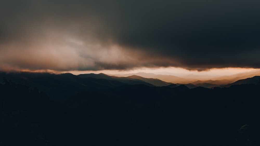 black mountain under gray clouds