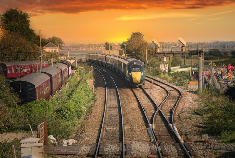 UK train on tracks at sunset