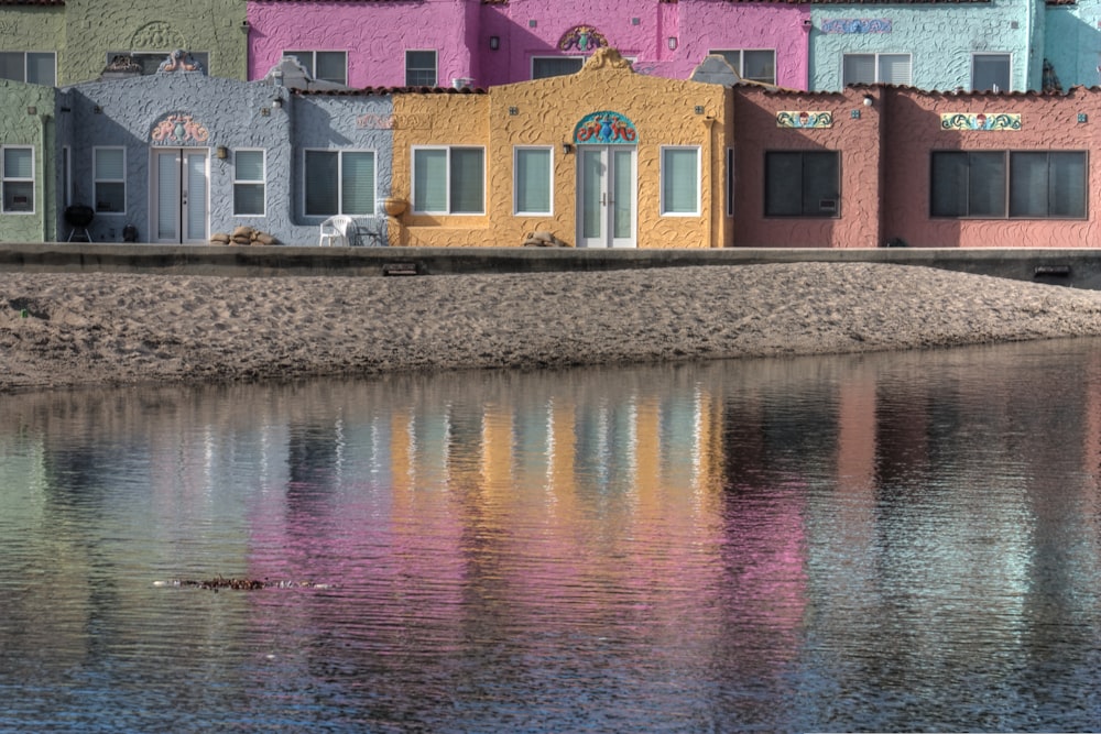 pink and white concrete building beside body of water during daytime