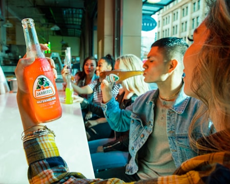 A happy family enjoying bottled drinks at a home gathering with a variety of options from nectar home.