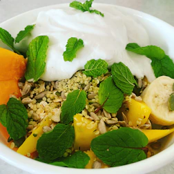 A vibrant food bowl inspired by Fijian flavors, garnished with fresh tropical ingredients.
