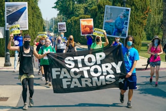 people walking in an animal rights march holding up banners