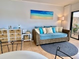 A cozy flat with beach-themed decor and a comfortable seating area.