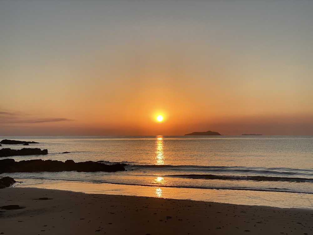 silhouette of people on beach during sunset