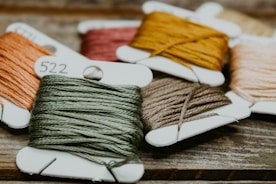 green and yellow yarn on brown wooden table
