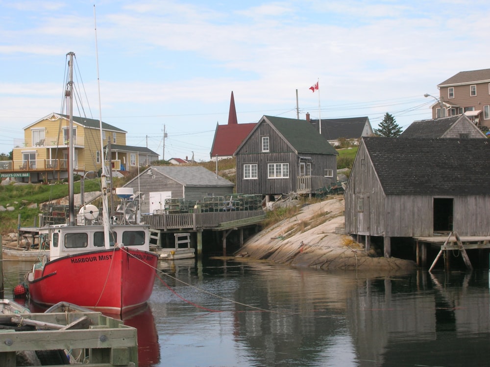 red and white boat on dock during daytime