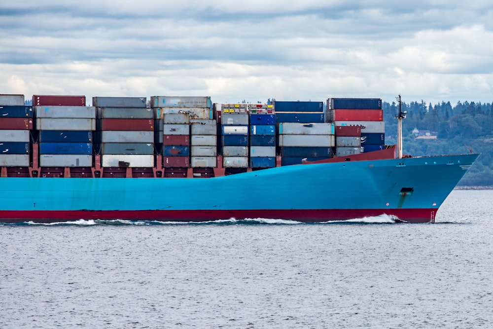 nave da carico rossa e blu in mare durante il giorno