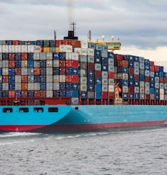 blue and red cargo ship on sea during daytime