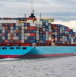 blue and red cargo ship on sea during daytime