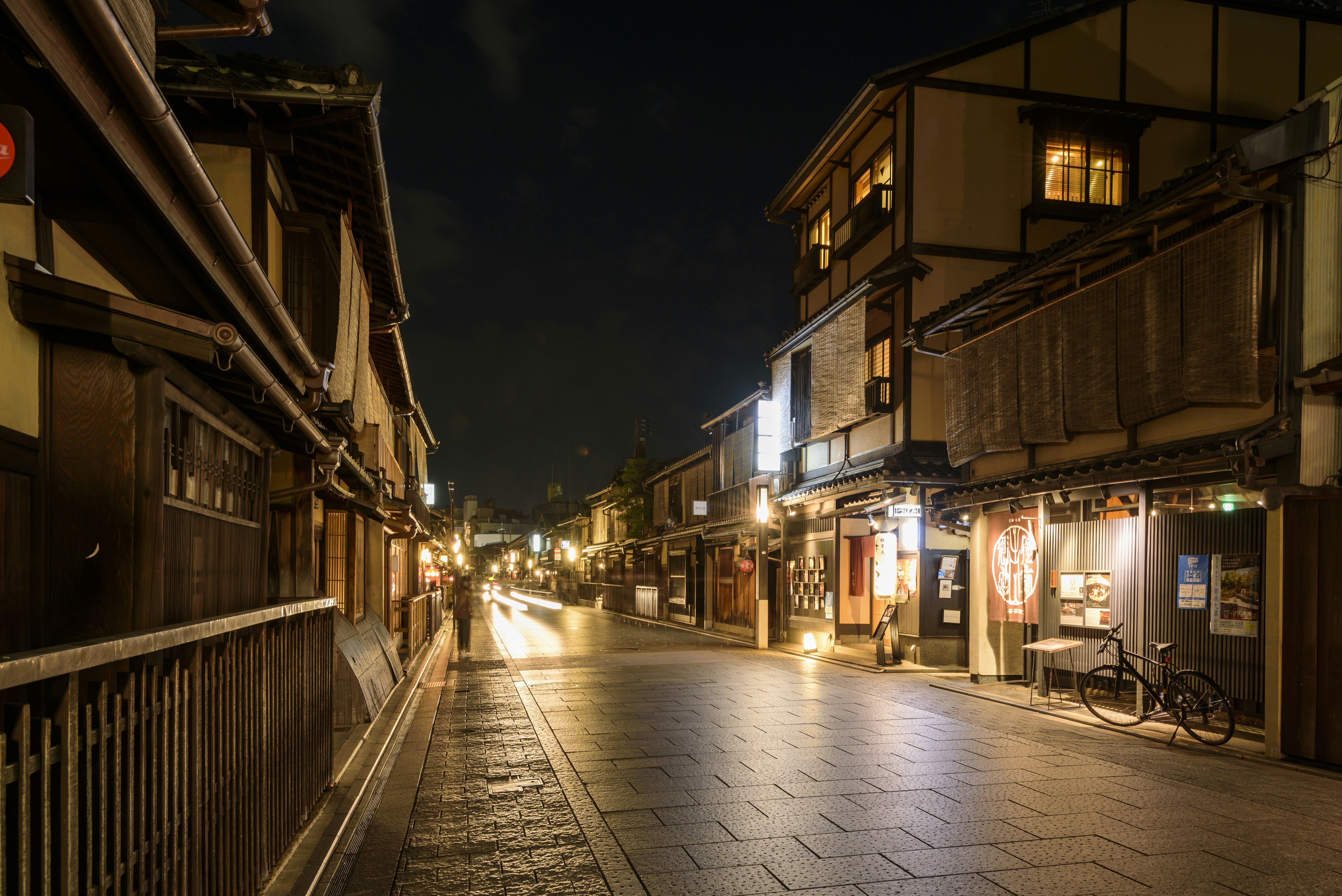 empty-street-with-lighted-lamp-posts-during-night-time