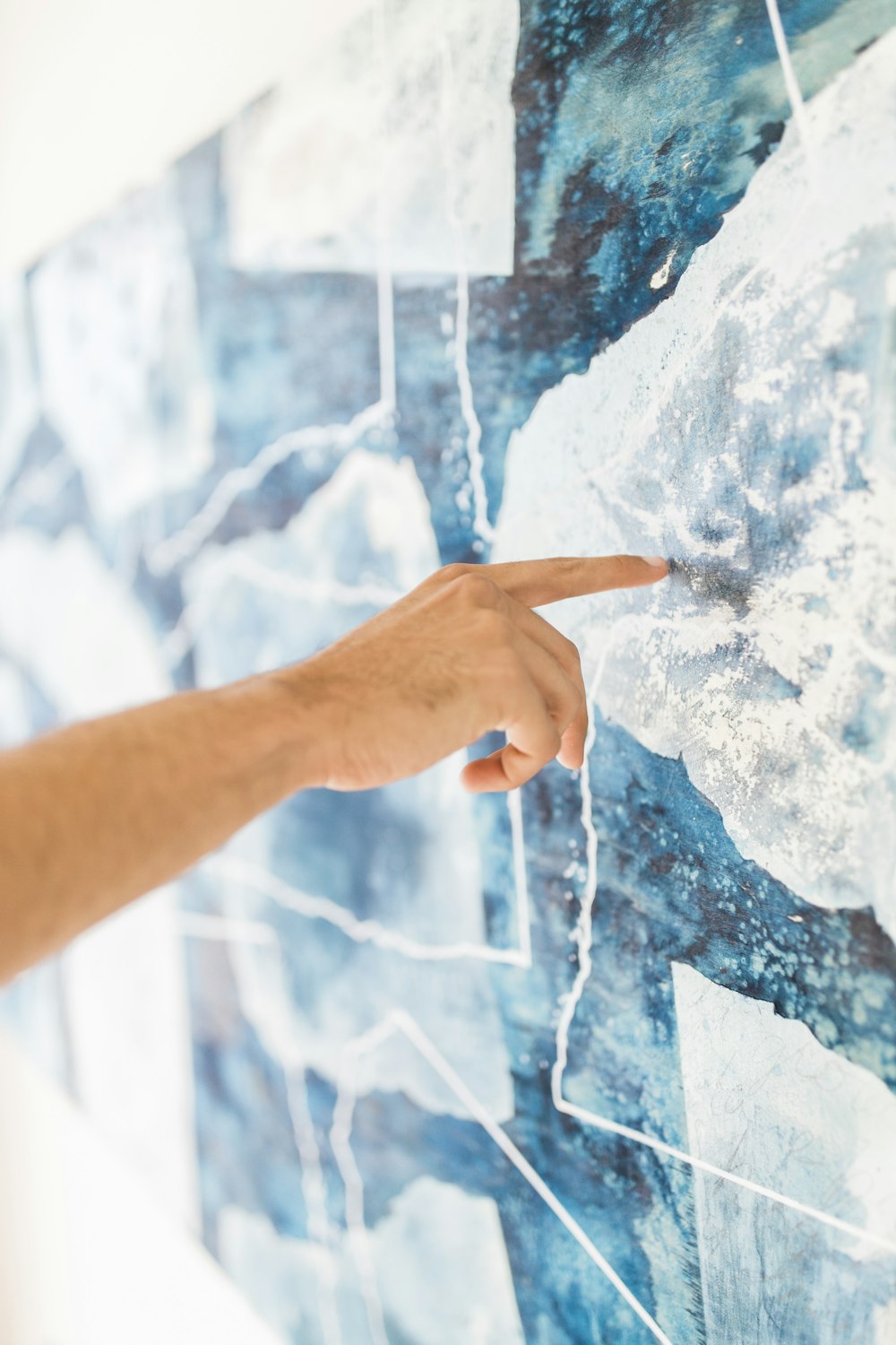 person holding blue and white paint