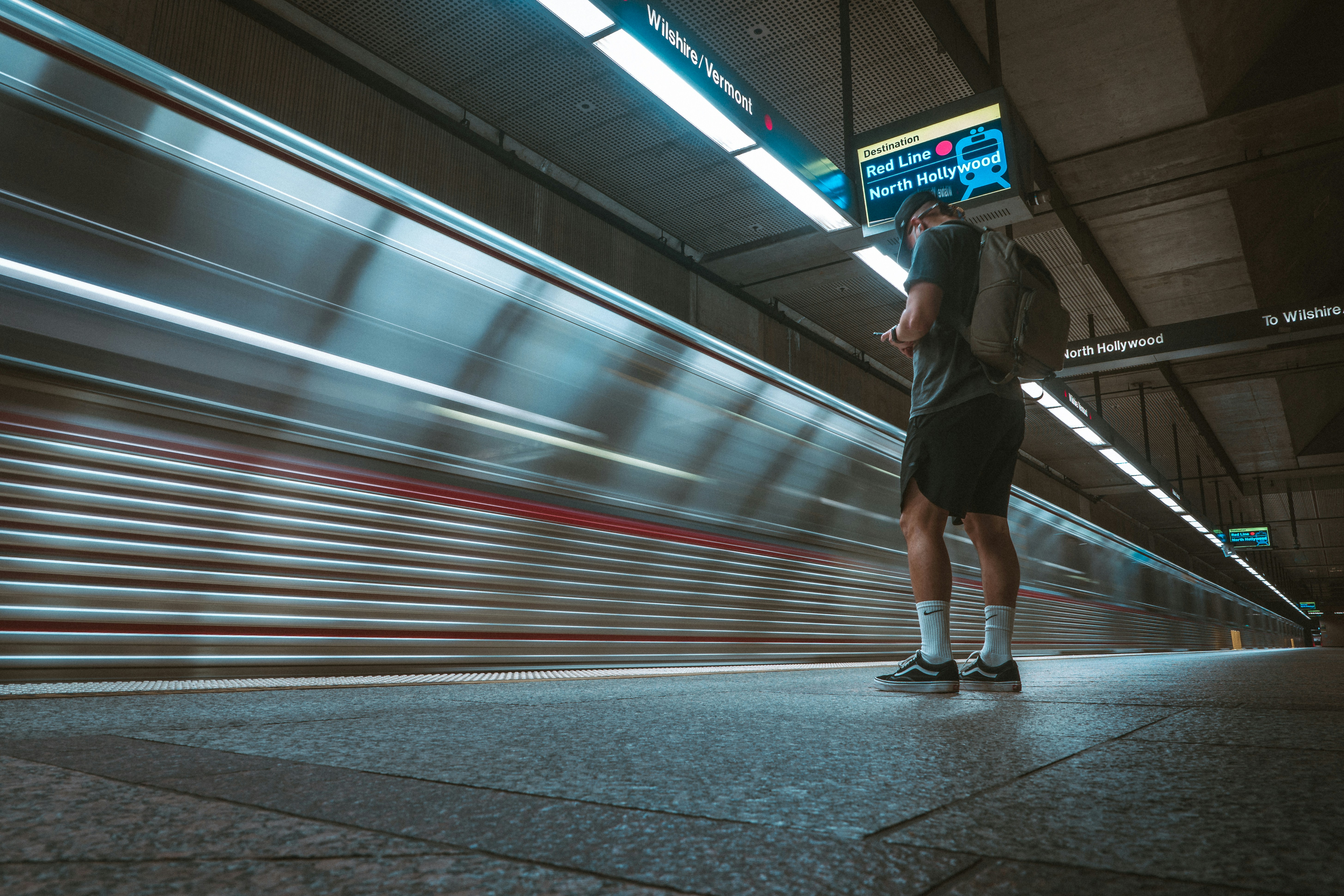woman in black jacket and black pants walking on sidewalk