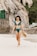 woman in blue bikini wearing brown sun hat