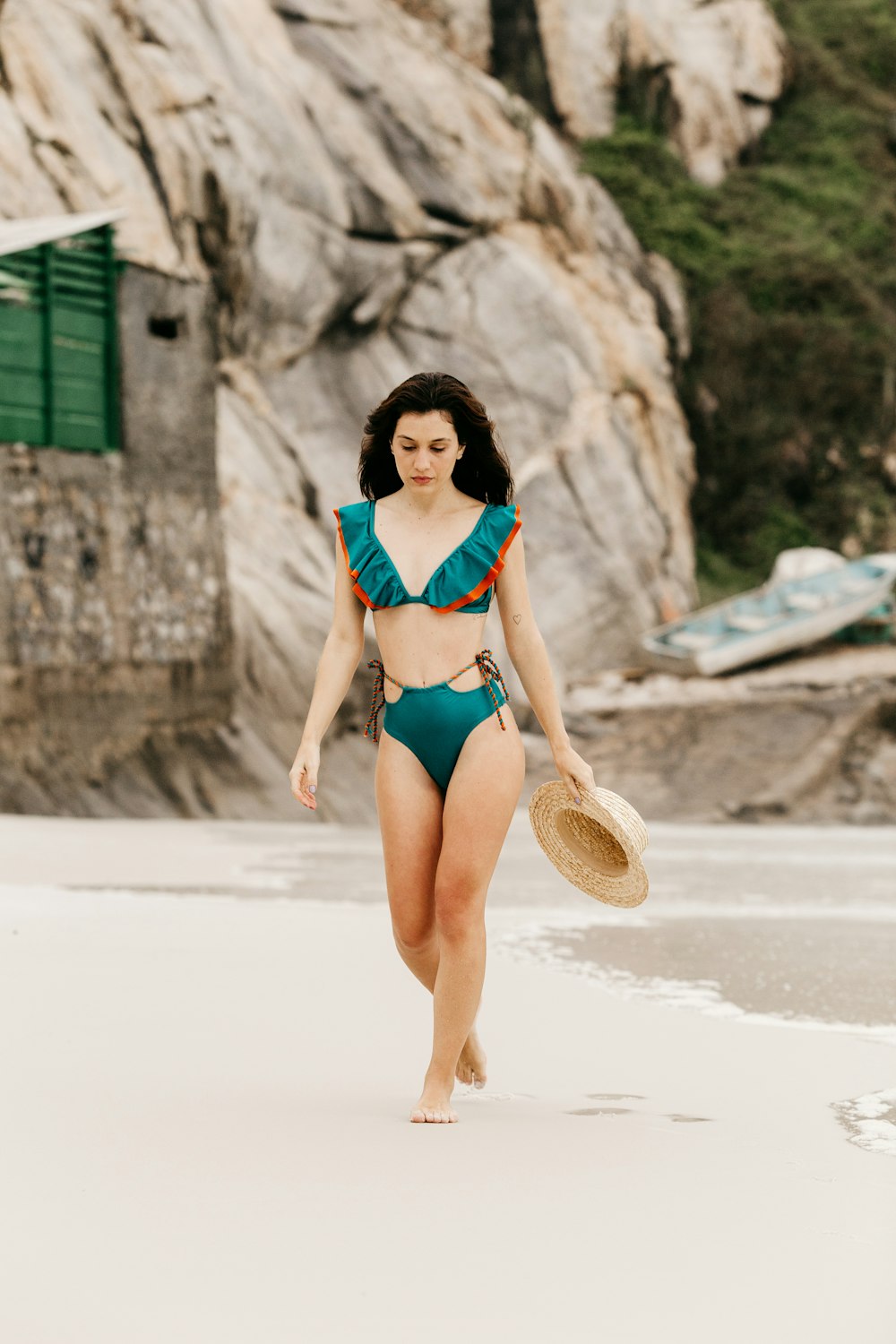 woman in blue bikini wearing brown sun hat